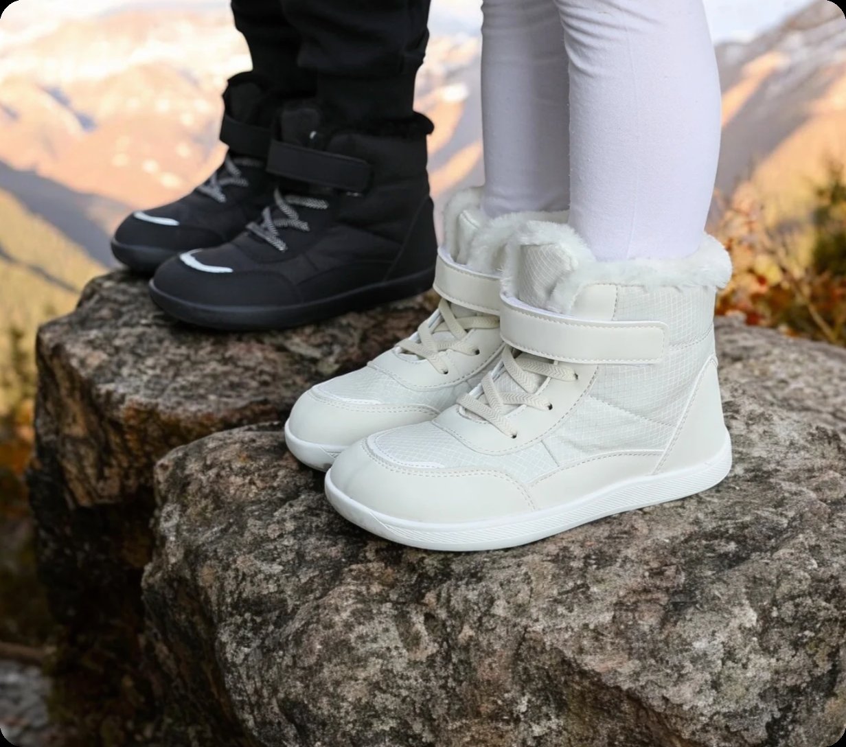 white and black kids barefoot winter shoes on the rock