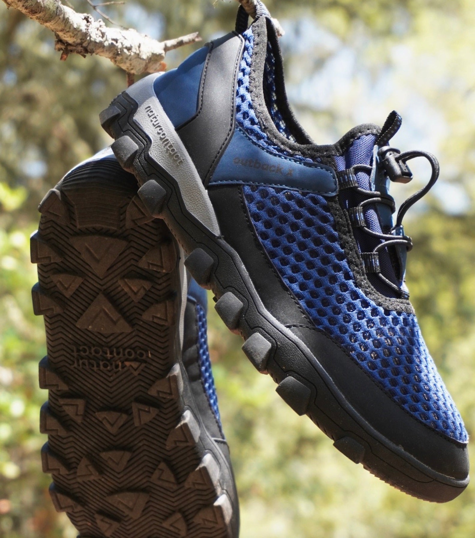 blue barefoot hiking shoes with a blurred background in nature