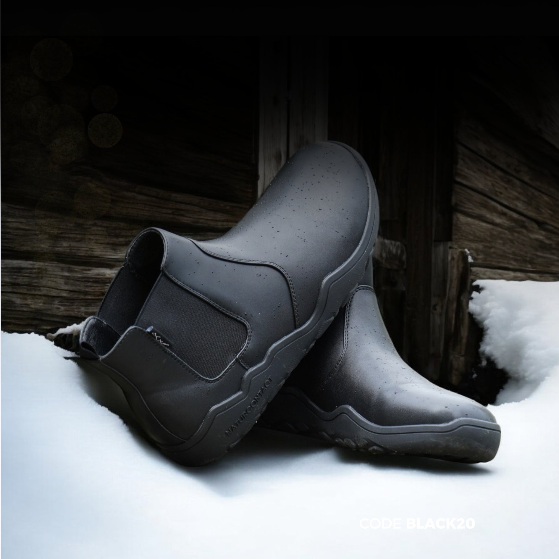black chealsea style boots on the snow