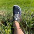 top view of blue barefoot shoes worn on grass summer