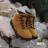 gold barefoot shoes on a rock suede leather