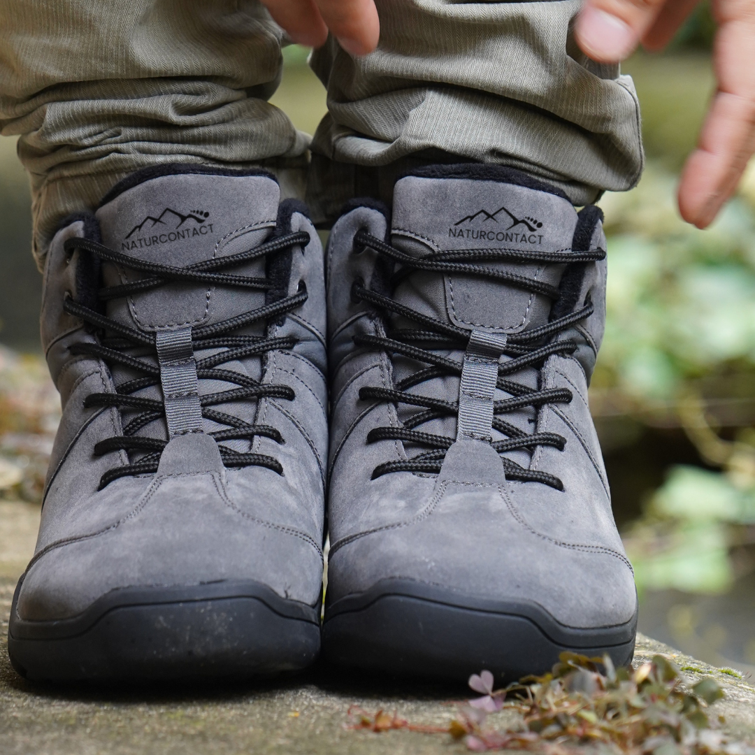 front view grey barefoot shoes ankle top on a rock