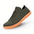 Green barefoot shoes with orange sole on a white background