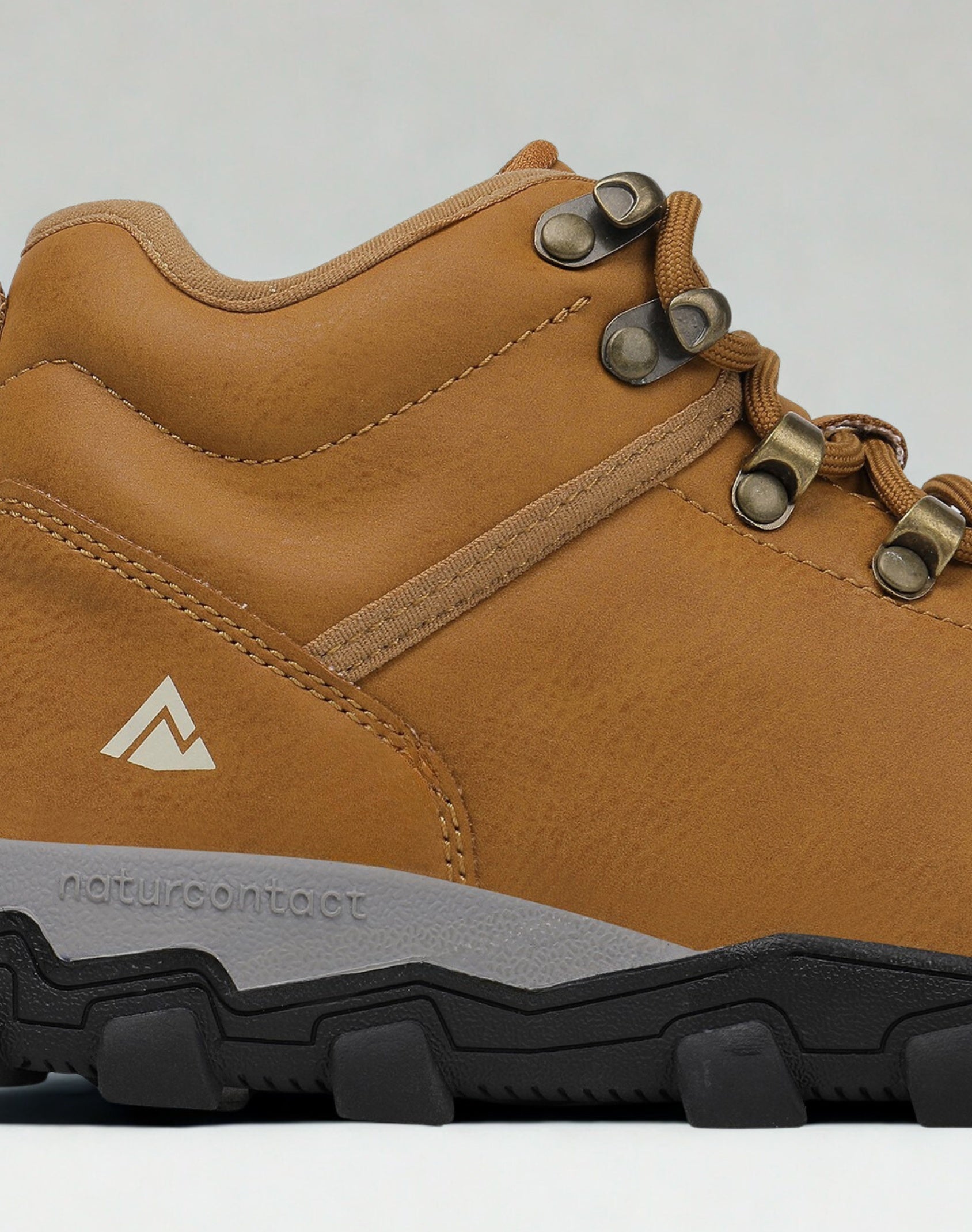 Brown hiking boot with visible brand logo on a light gray background