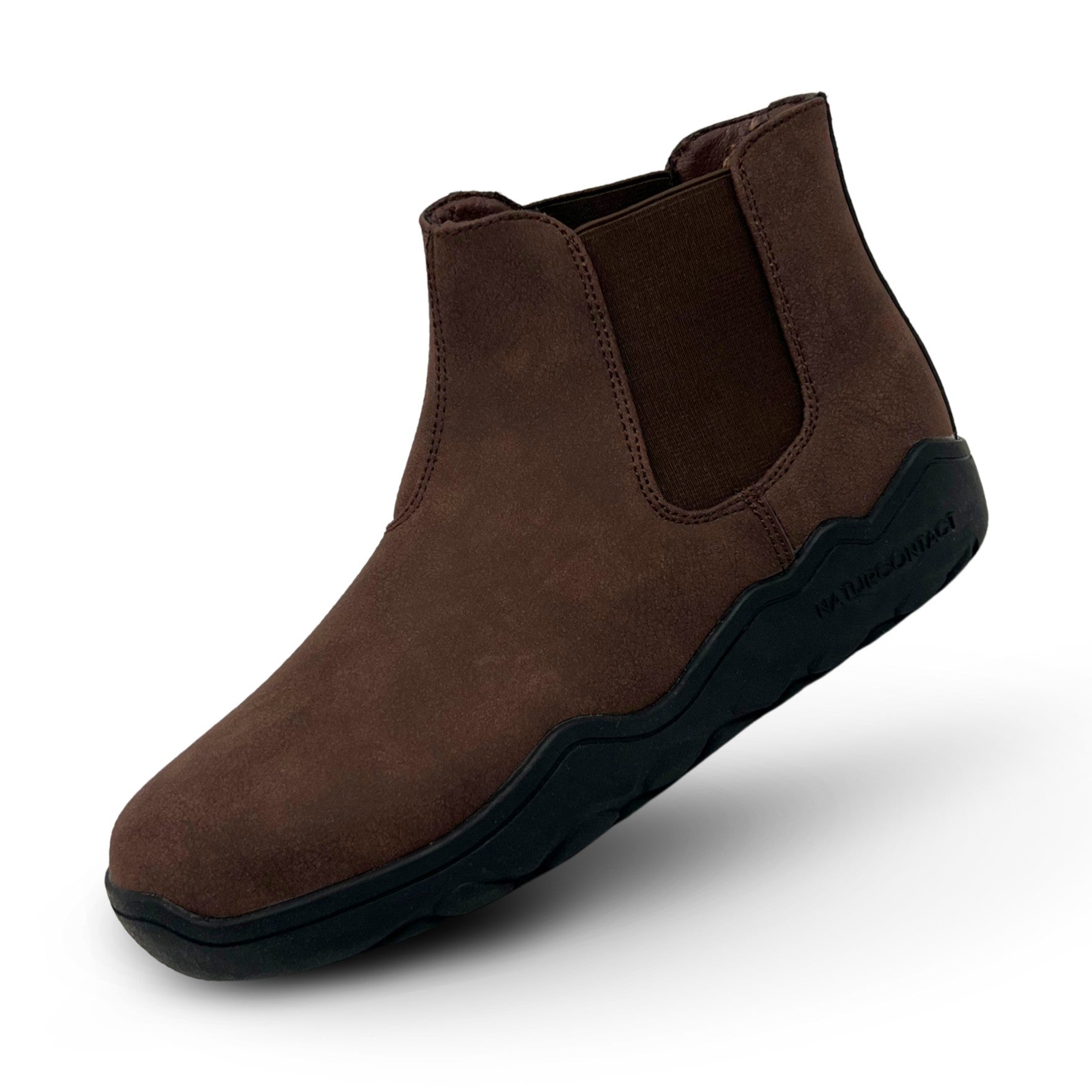 Brown Chelsea boot with black sole on a white background