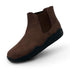Brown Chelsea boot with black sole on a white background
