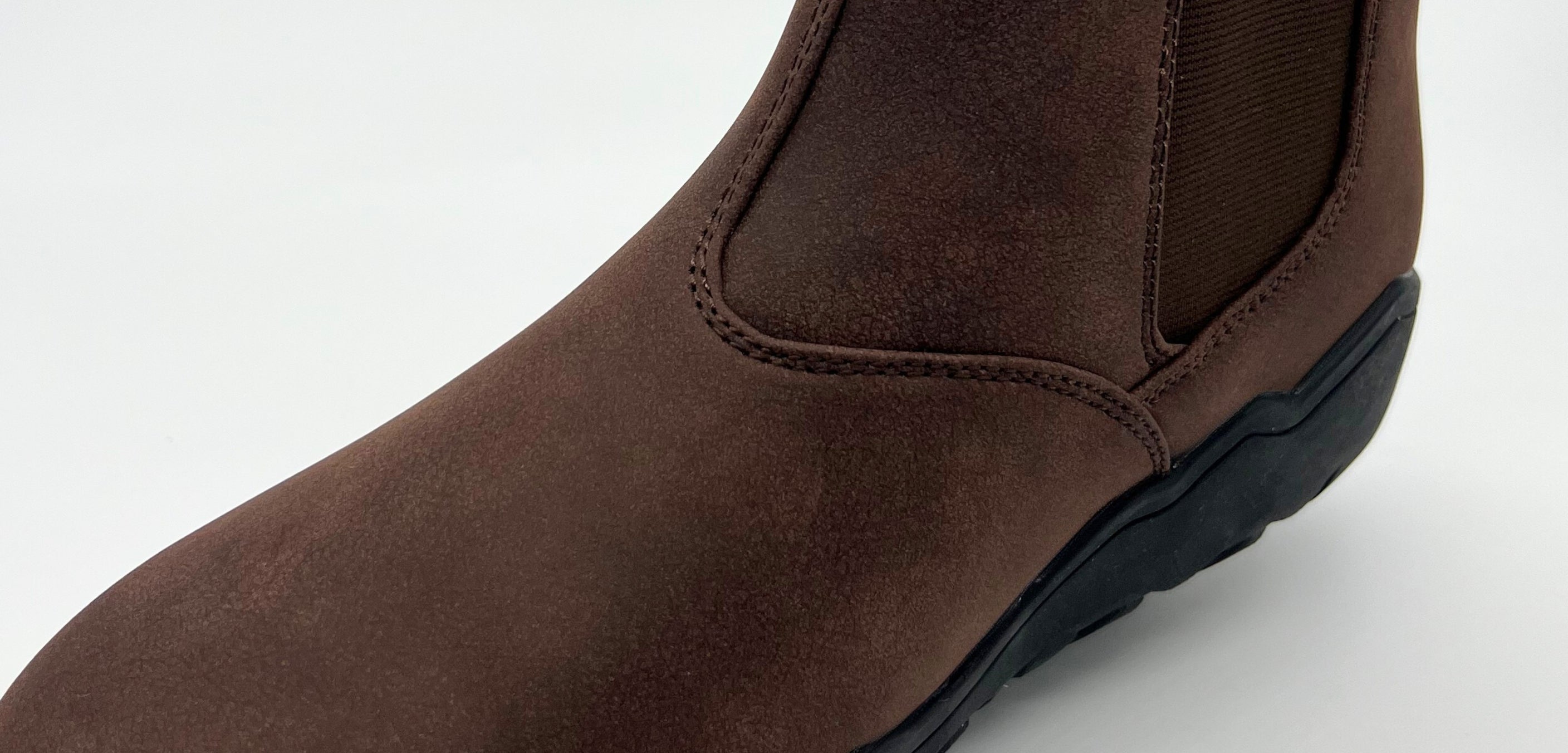 Brown leather boot on a white background