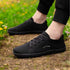 side view of black minimalist summer barefoot shoes on the grass