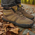 Brown hiking boots with visible brand logo on a forest floor.