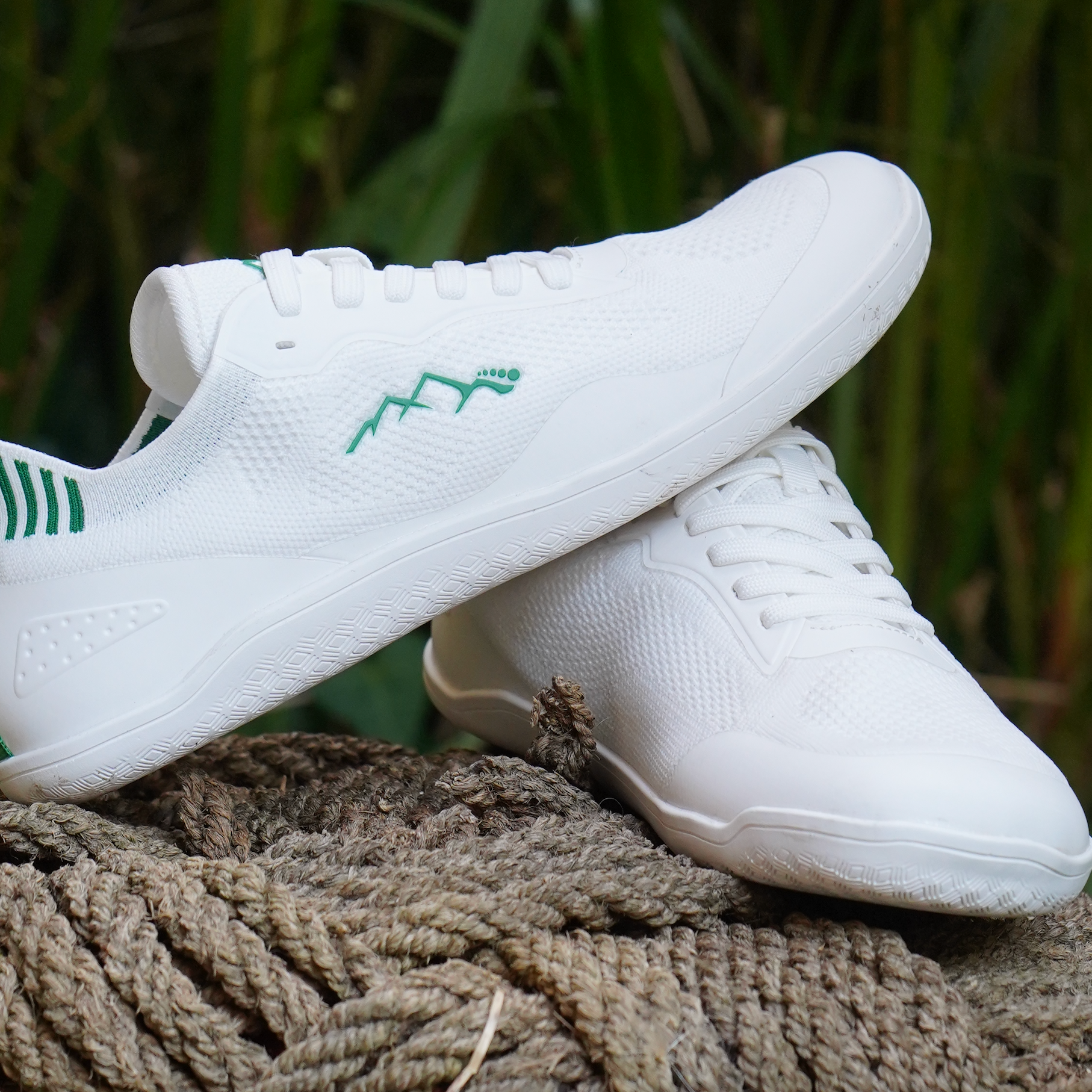 white barefoot shoes on a rope in nature side view