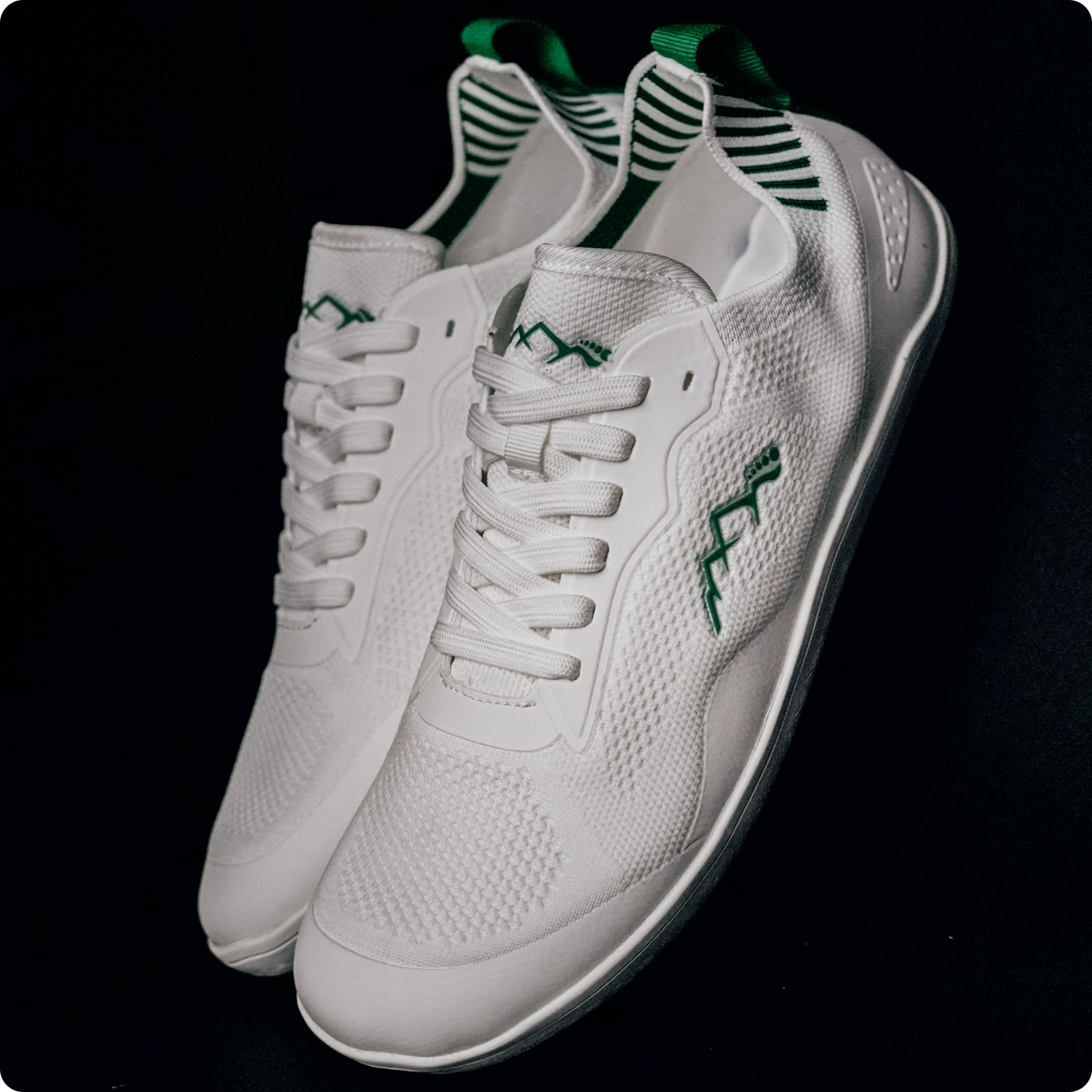 white and green barefoot summer shoes in studio