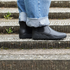 side view of black barefoot chelsea minimalisdt boots on stairs