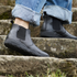 side view of black barefoot chelsea boots on stairs