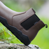 side view of brown chelsea barefoot boots on a rock