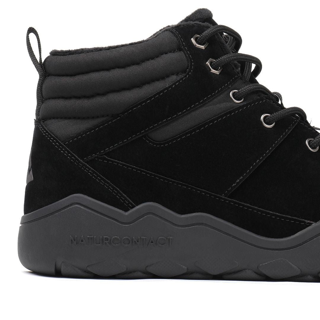 Black winter barefoot shoe with black laces on a white background, featuring 'Naturcontact' branding. close-up side view.