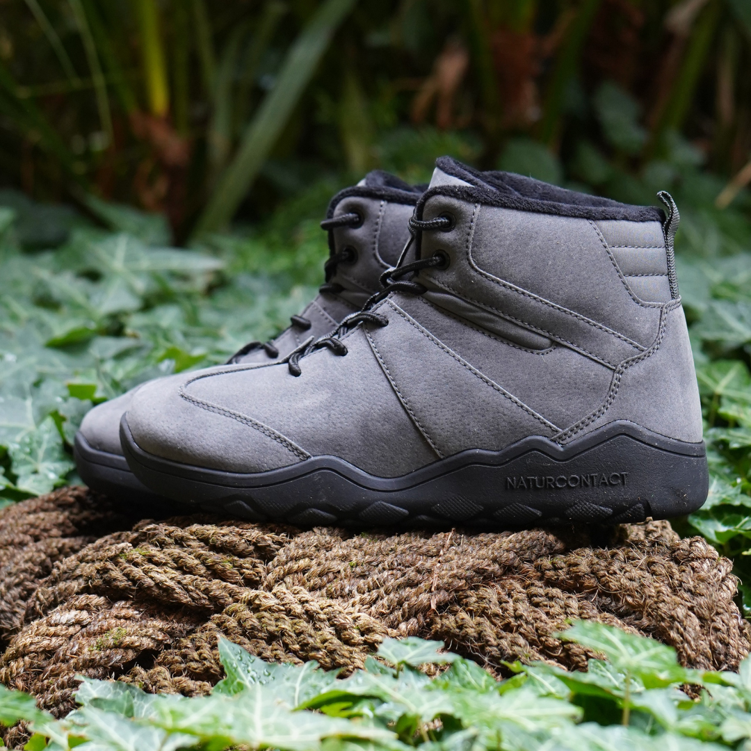 side view suede leather barefoot shoes on a rope in nature