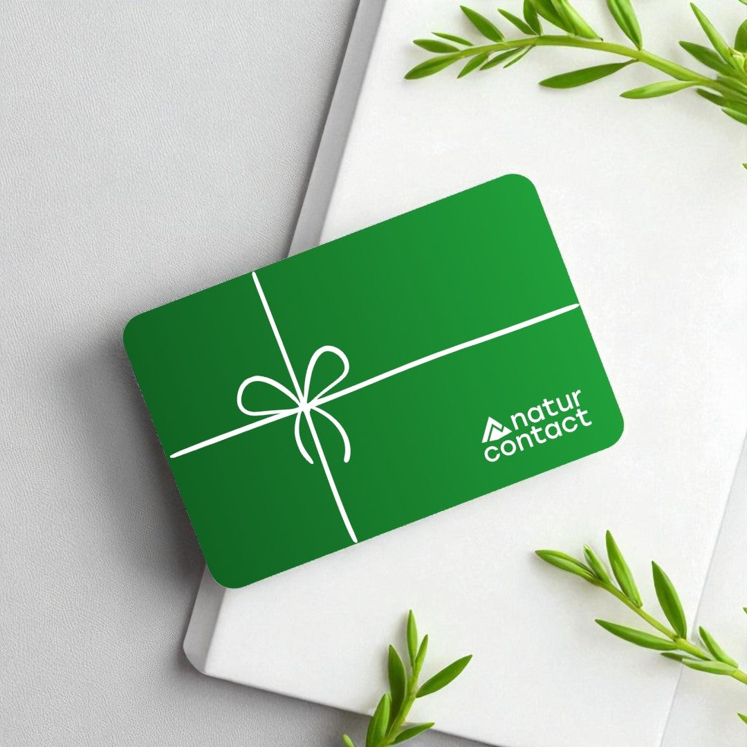 Green gift card with 'natur contact' logo on a white surface with green leaves.