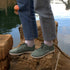 summer minimalistic barefoot shoes on a rick sage green on the sea