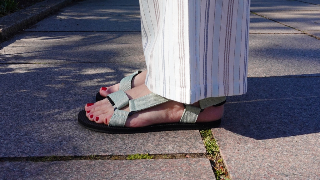 Woman wearing flexible barefoot sandals while walking outdoors