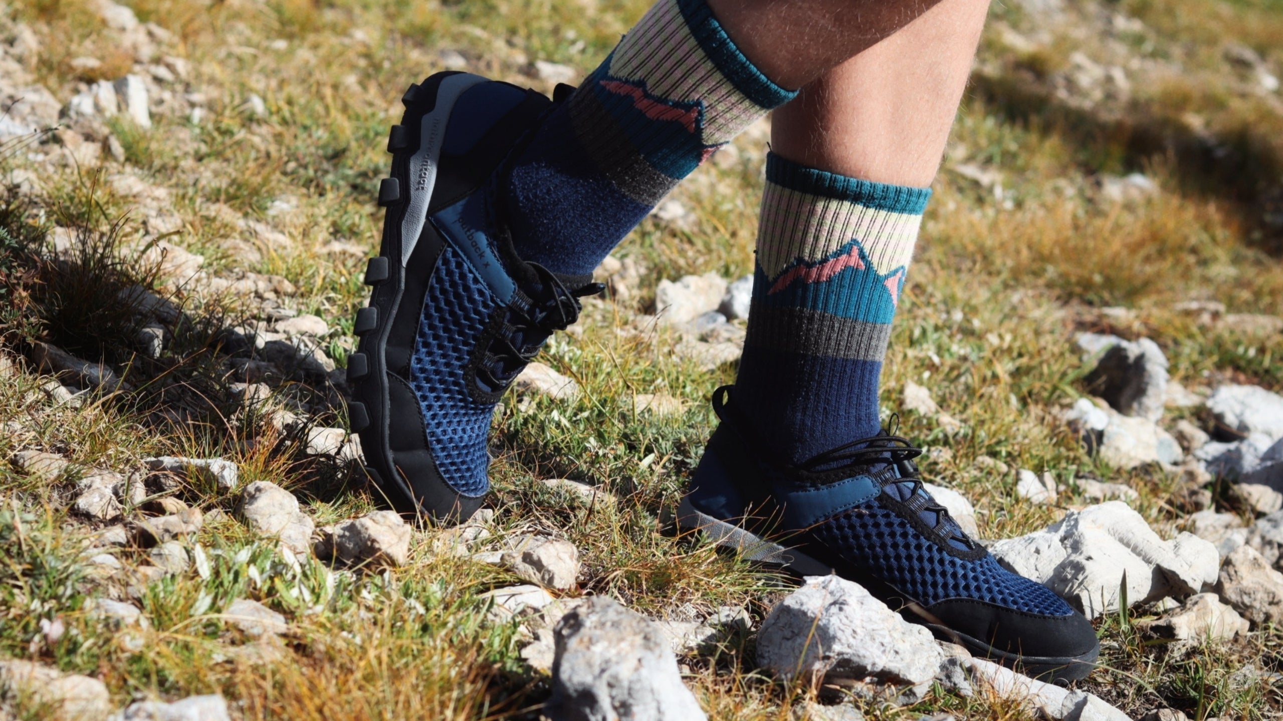 Walking on rocky terrain using barefoot shoes to strengthen feet naturally