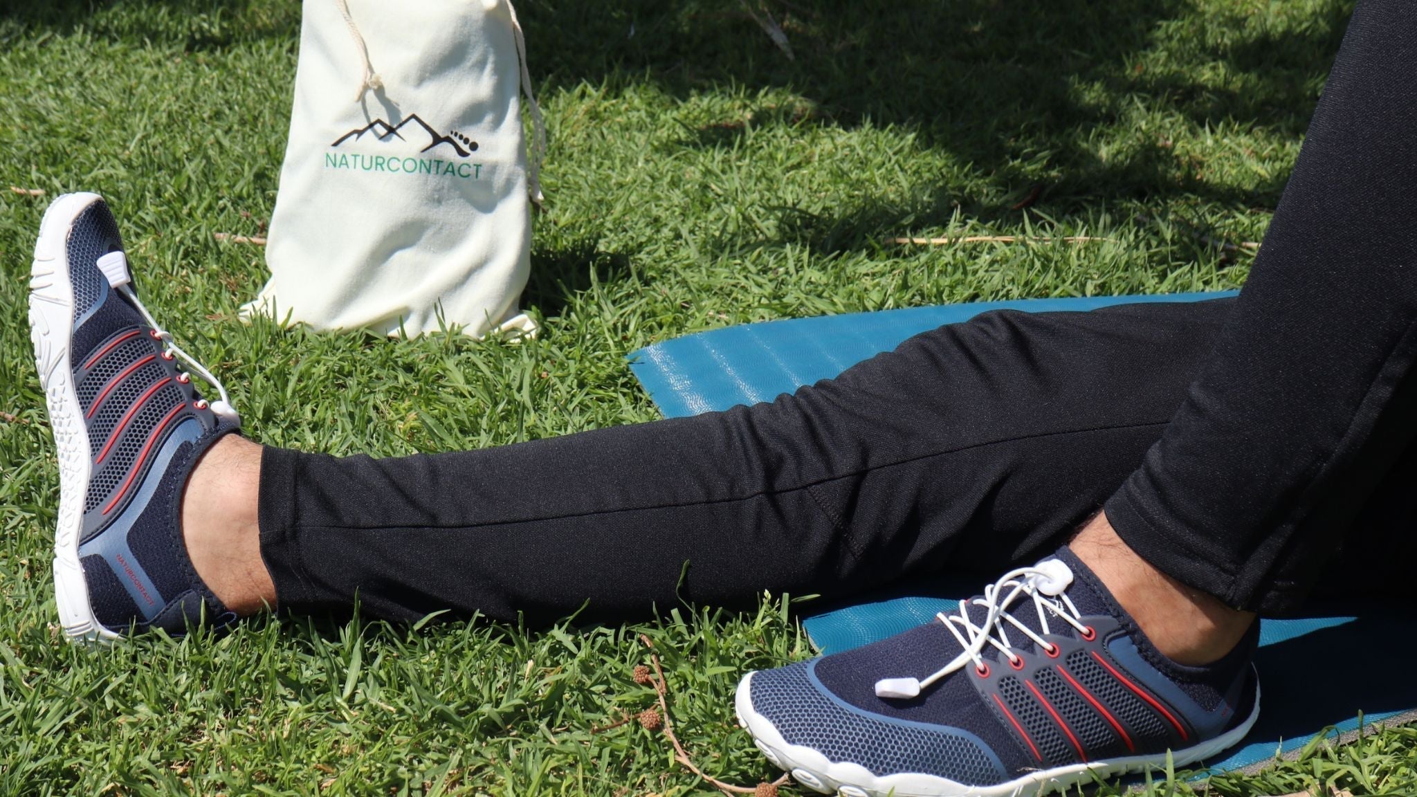barefoot shoes with toes placed on grass showing flexible sole and wide toe box