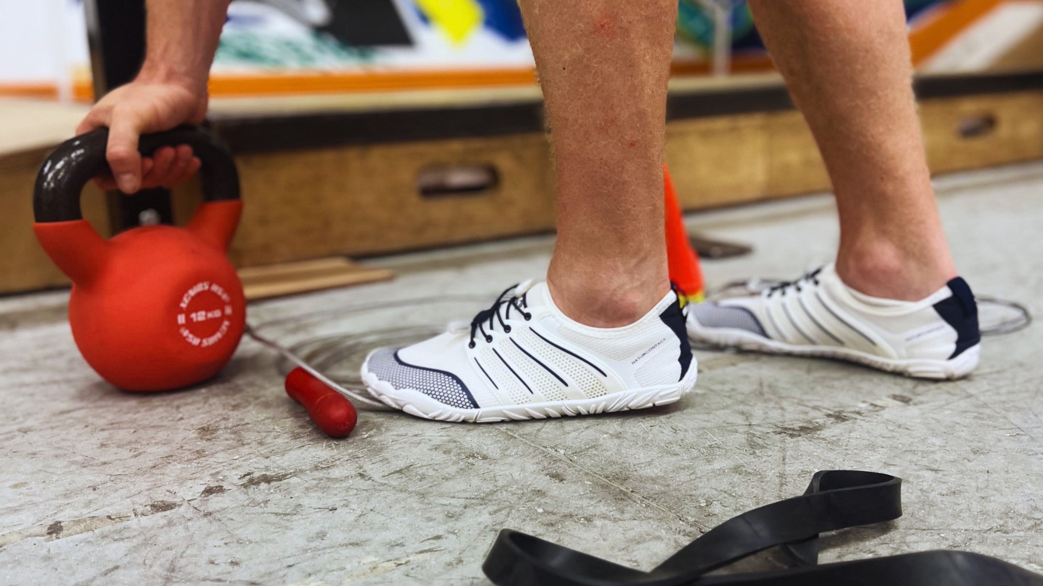naturcontact barefoot shoes during gym training with kettlebell showing stability and natural foot movement