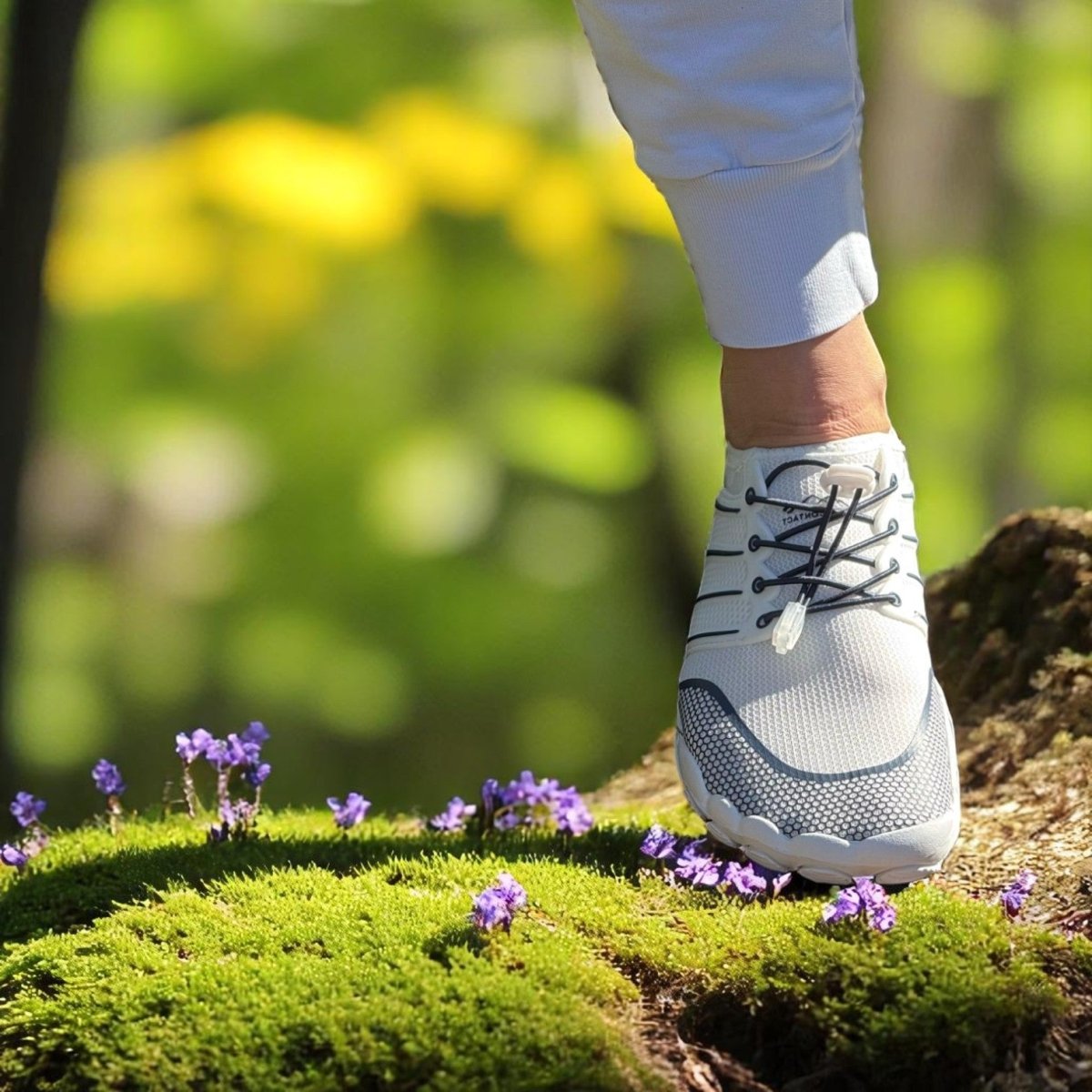 white and blue barefoot shoes on grass with bluured natural background