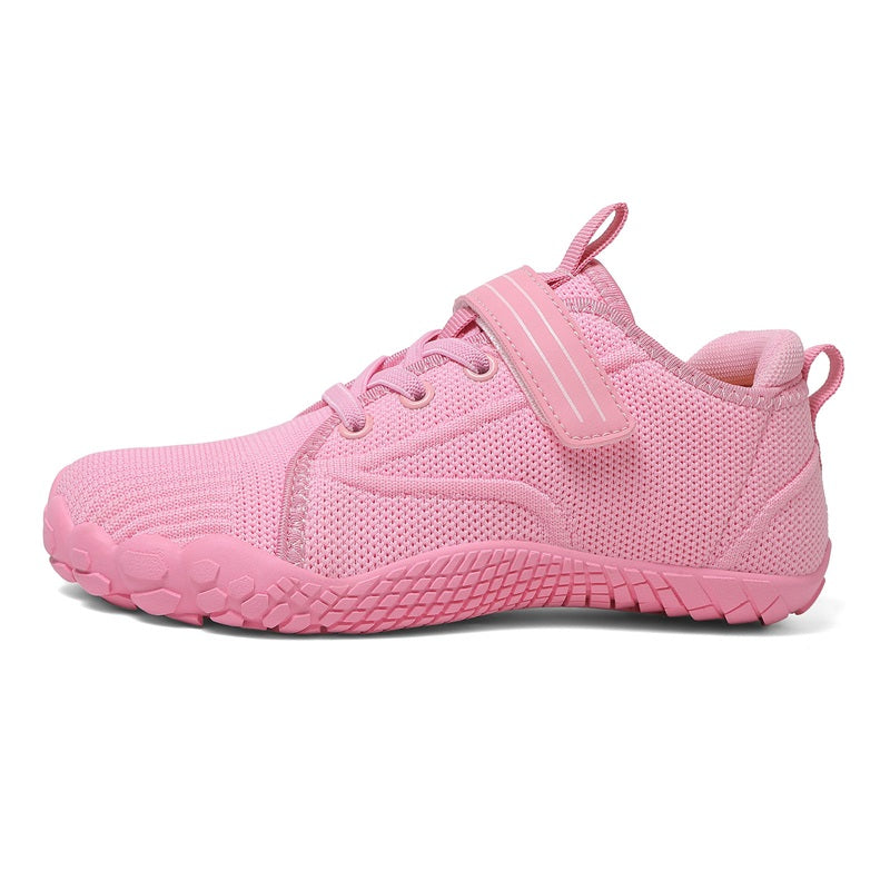 Pink barefoot sneaker for kids with a strap on, side view