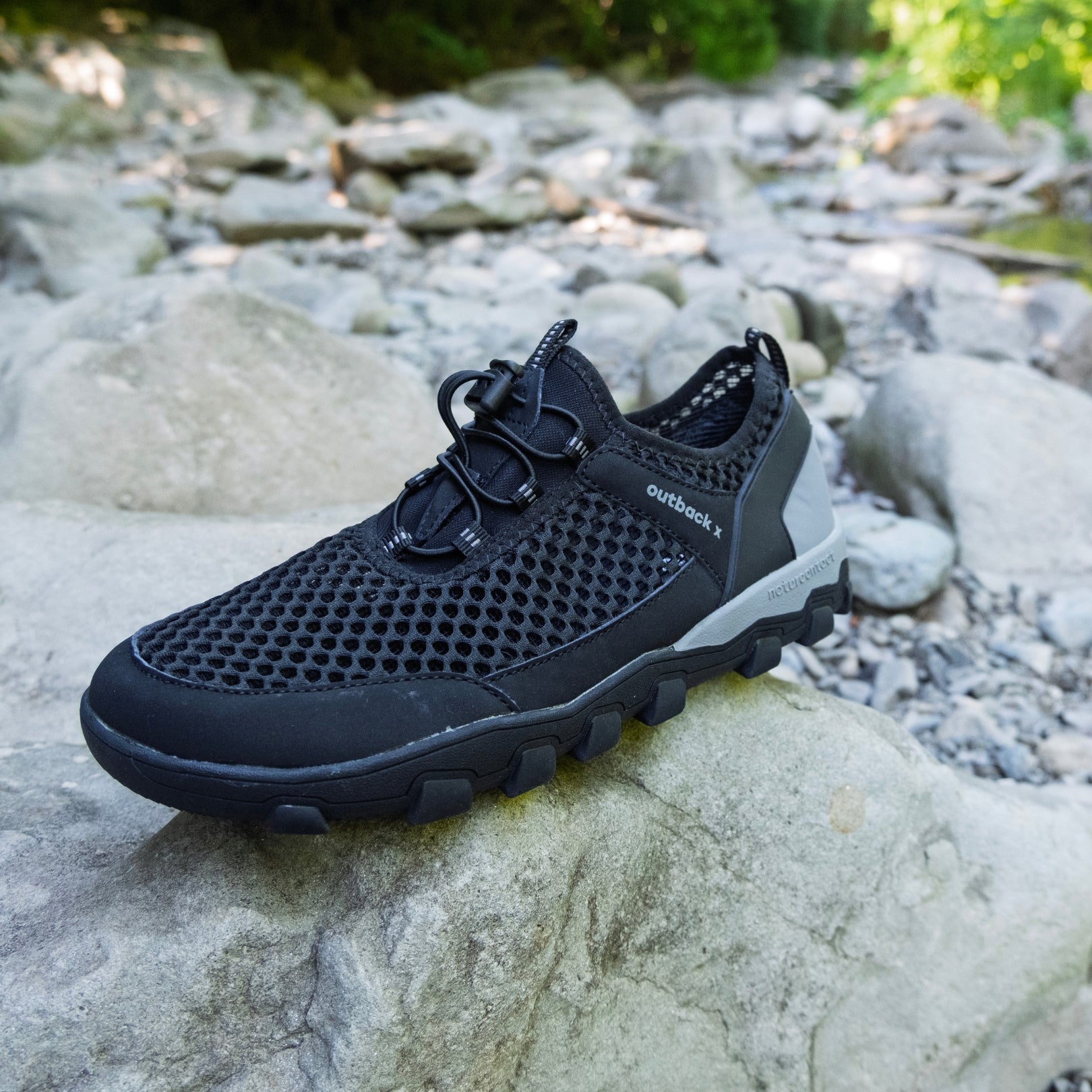 Black hiking barefoot shoe on natural rock landscape