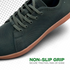 Green sneaker with brown sole on a white background, highlighting non-slip grip feature.