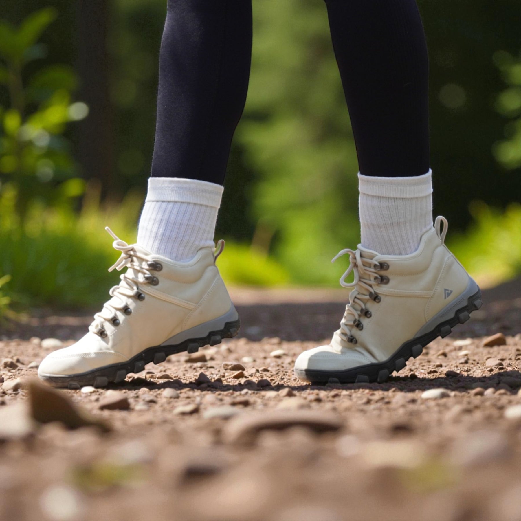 Close-up of minimalist hiking boots walking on a natural trail, promoting barefoot-style movement and outdoor exploration