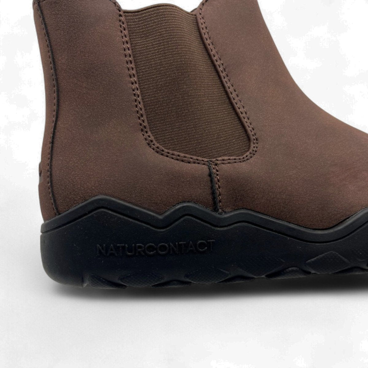 Brown shoe with 'Naturcontact' branding on a white background