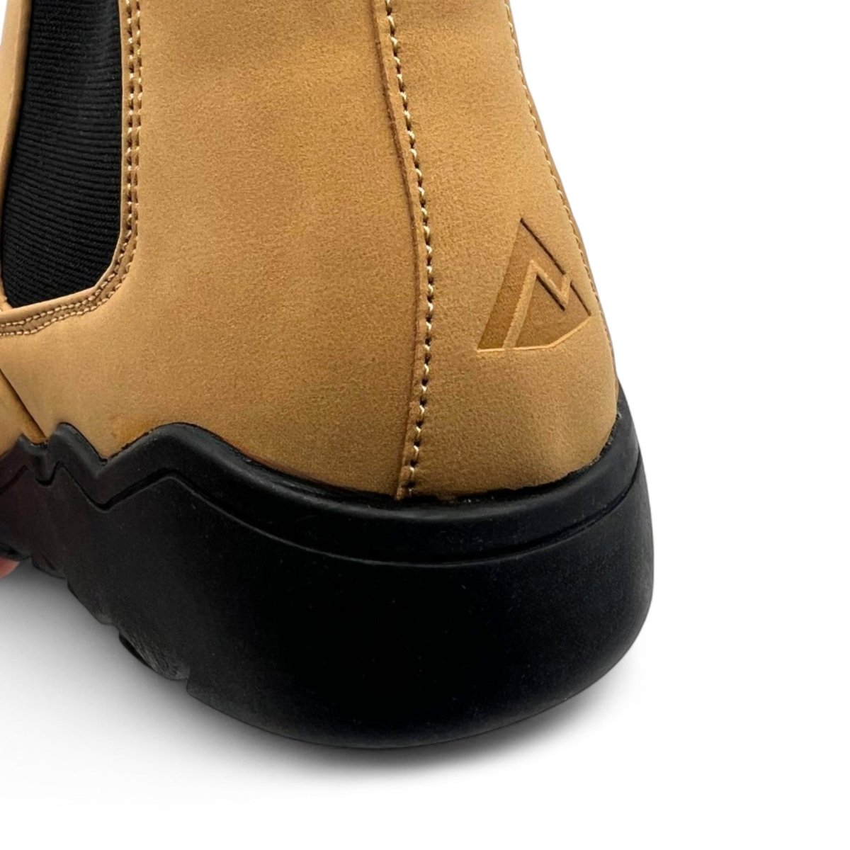 Close-up of a tan shoe with a black sole on a white background