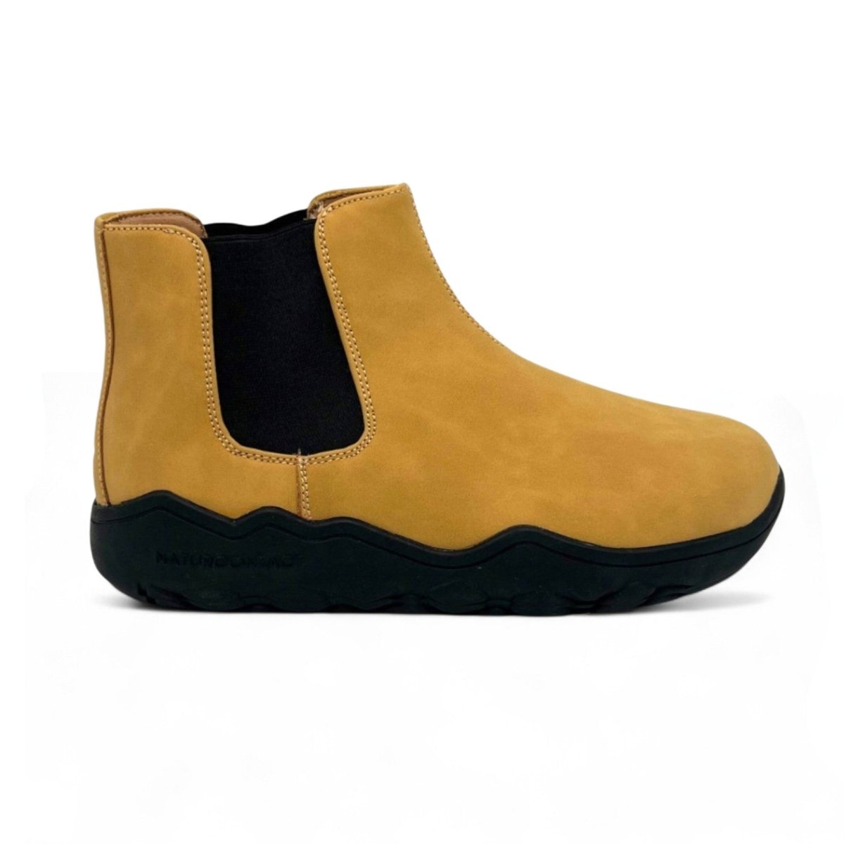Yellow Chelsea boot with black sole on a white background