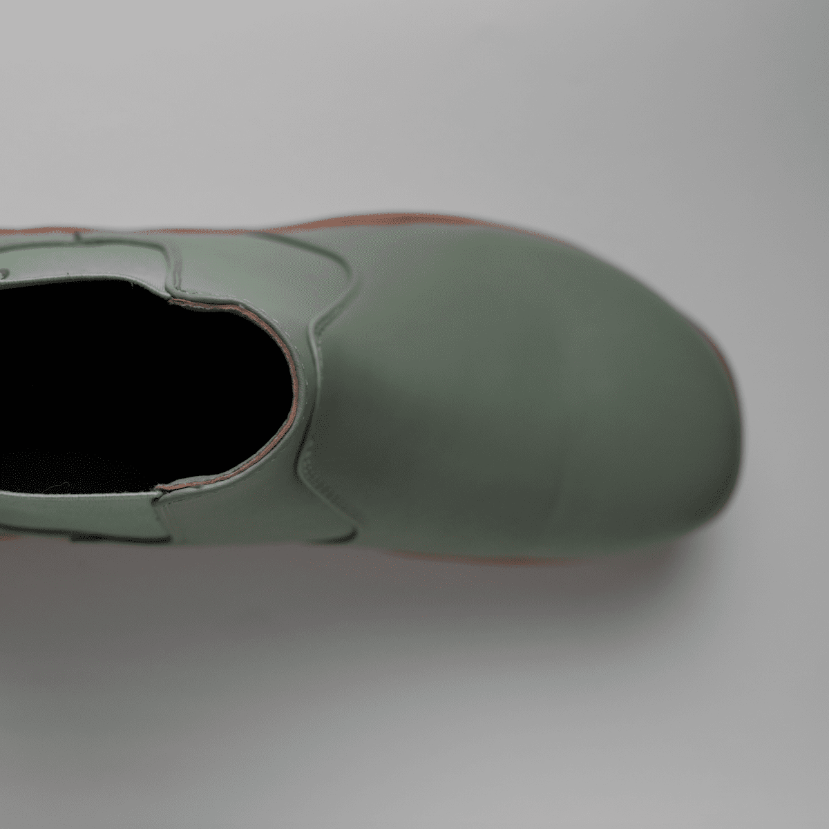 top studio view of wide toe box barefoot chelsea boots Sage Green