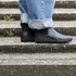 side view of Black barefoot chelsea minimalisdt boots on stairs