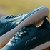 detail of teal barefoot shoes with white soles