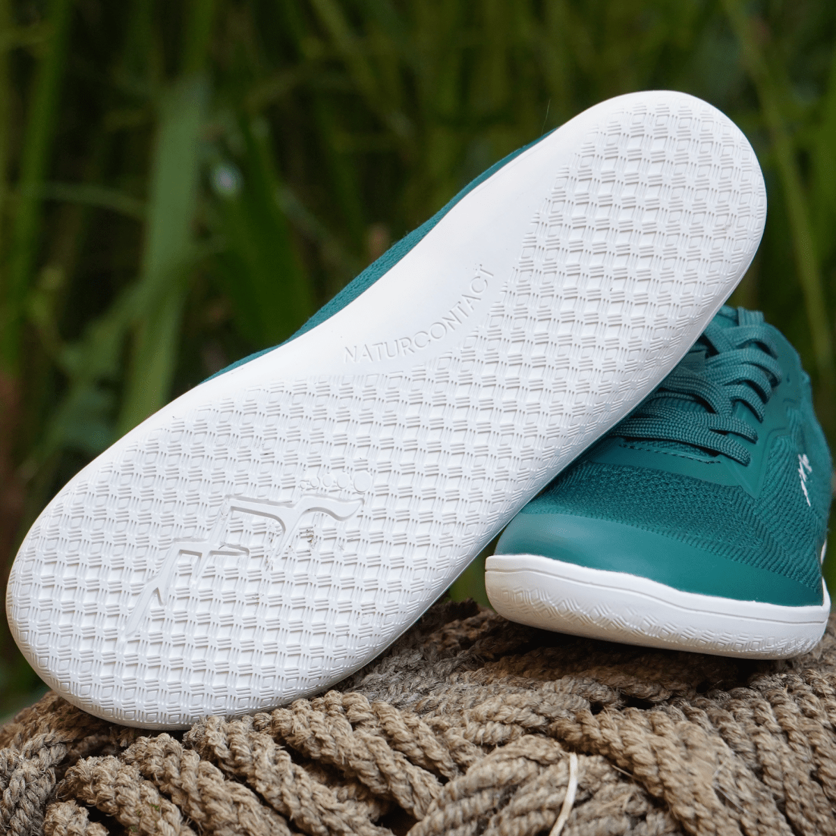 sole details of summer barefoot shoes teal on a rope in the nature