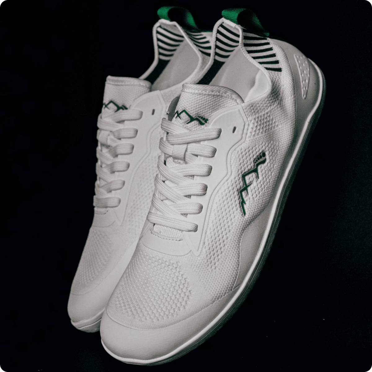 white and green barefoot summer shoes in studio