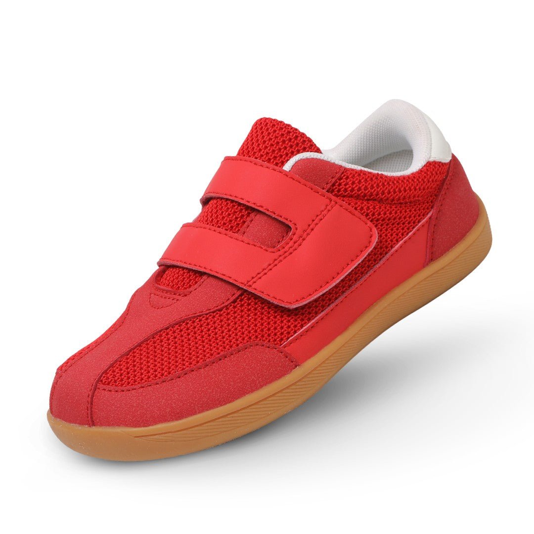 red barefoot sneaker for kids with brown sole on a white background