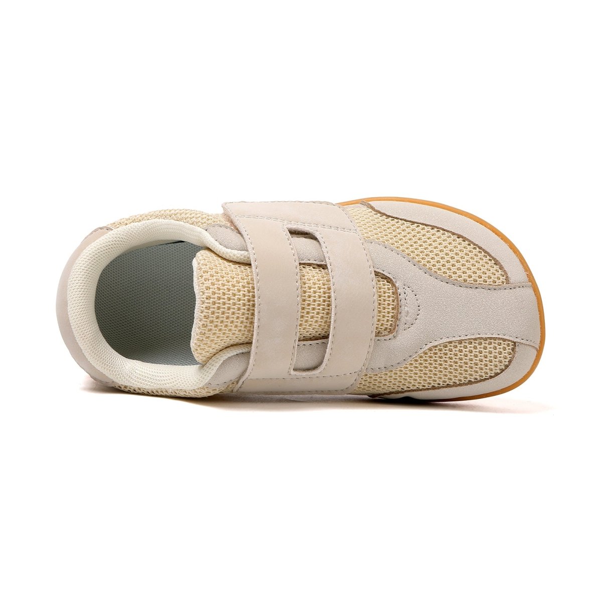 Beige children's barefoot shoe with velcro straps on a white background