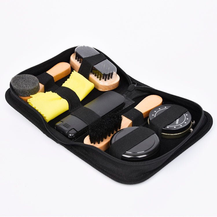 Set of shoe care tools in a black case on a white background