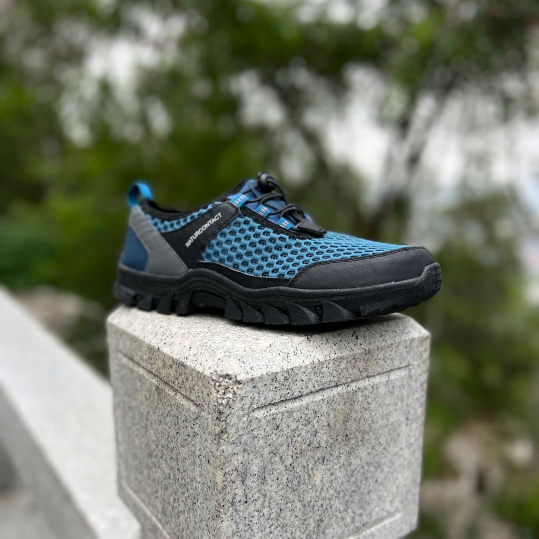 side view of blue hiking trekking barefoot shoes on a rock