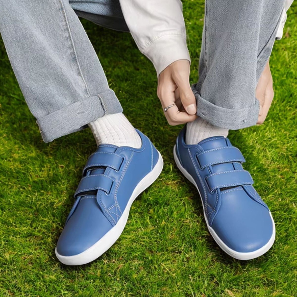 blue barefoot shoes with velcro worn on grass