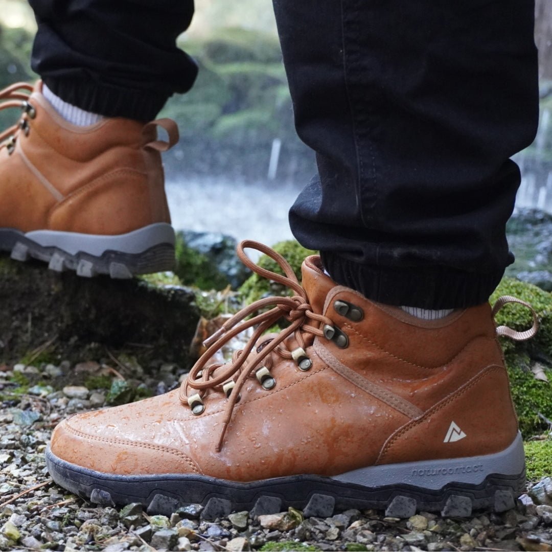 Tobacco hiking barefoot boots with laces on a natural background