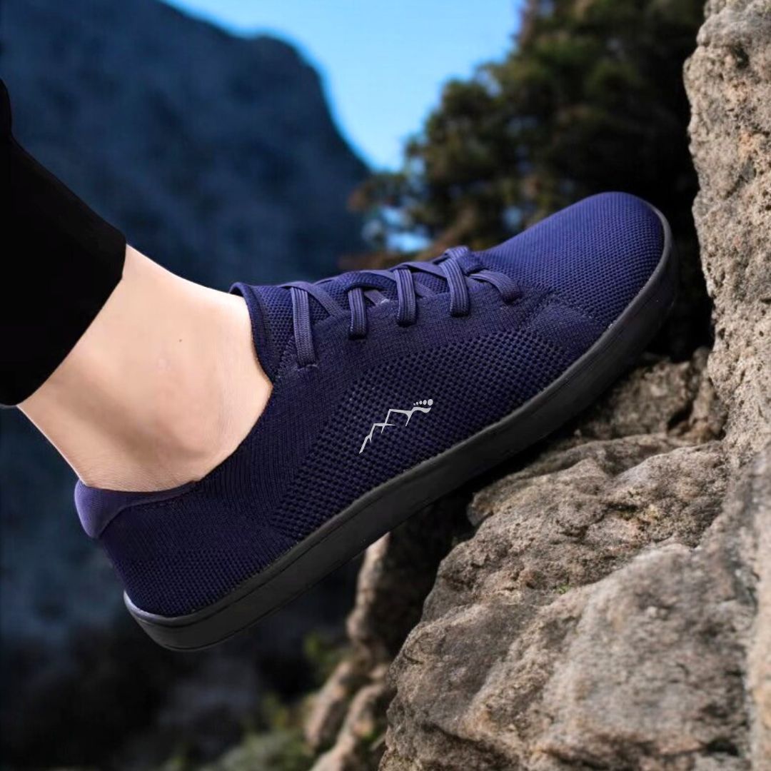 blue barefoot shoes on a rock mountain summer