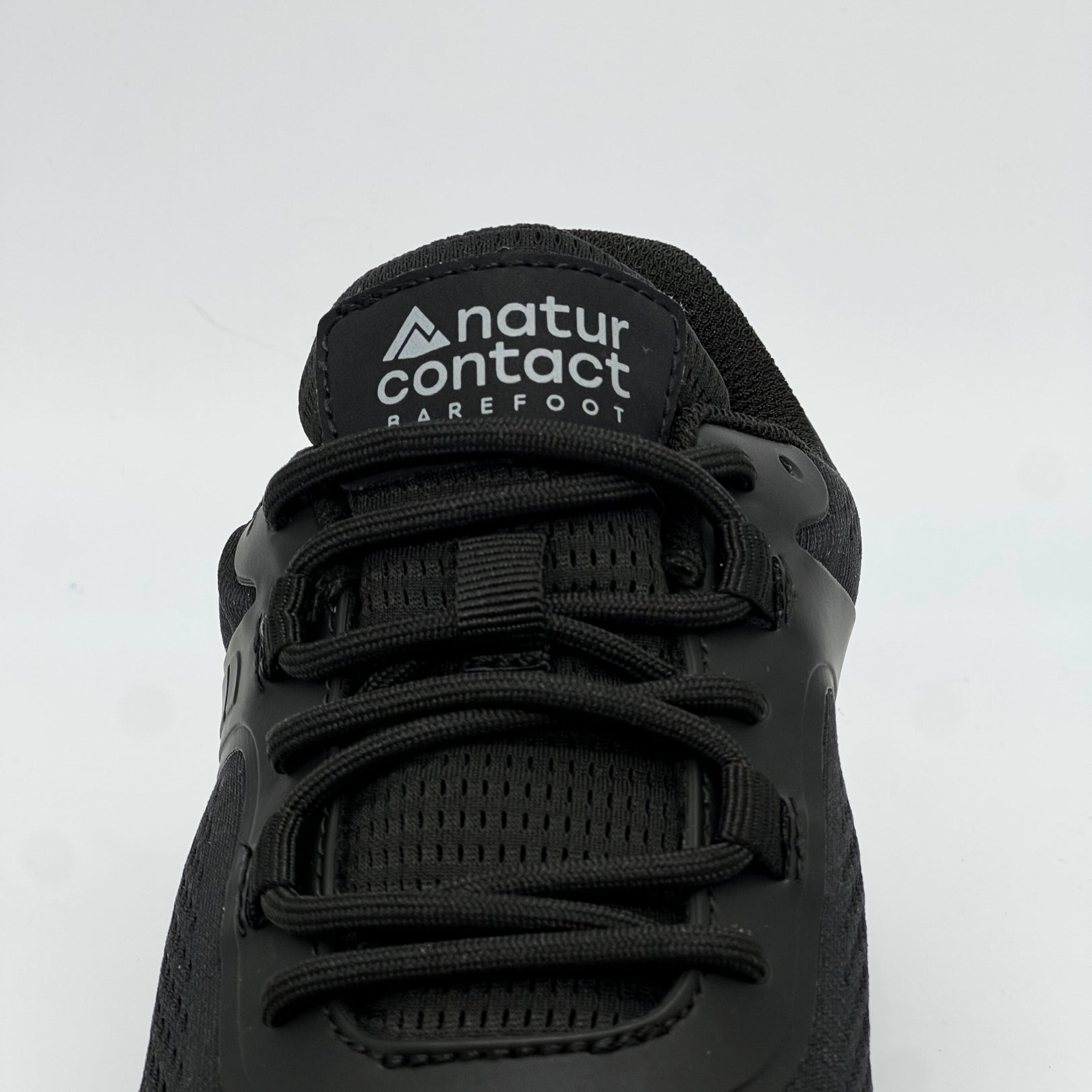 black daily barefoot shoes with detail shot of the shoe laces and tongue