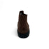 Brown boot with black sole on a white background