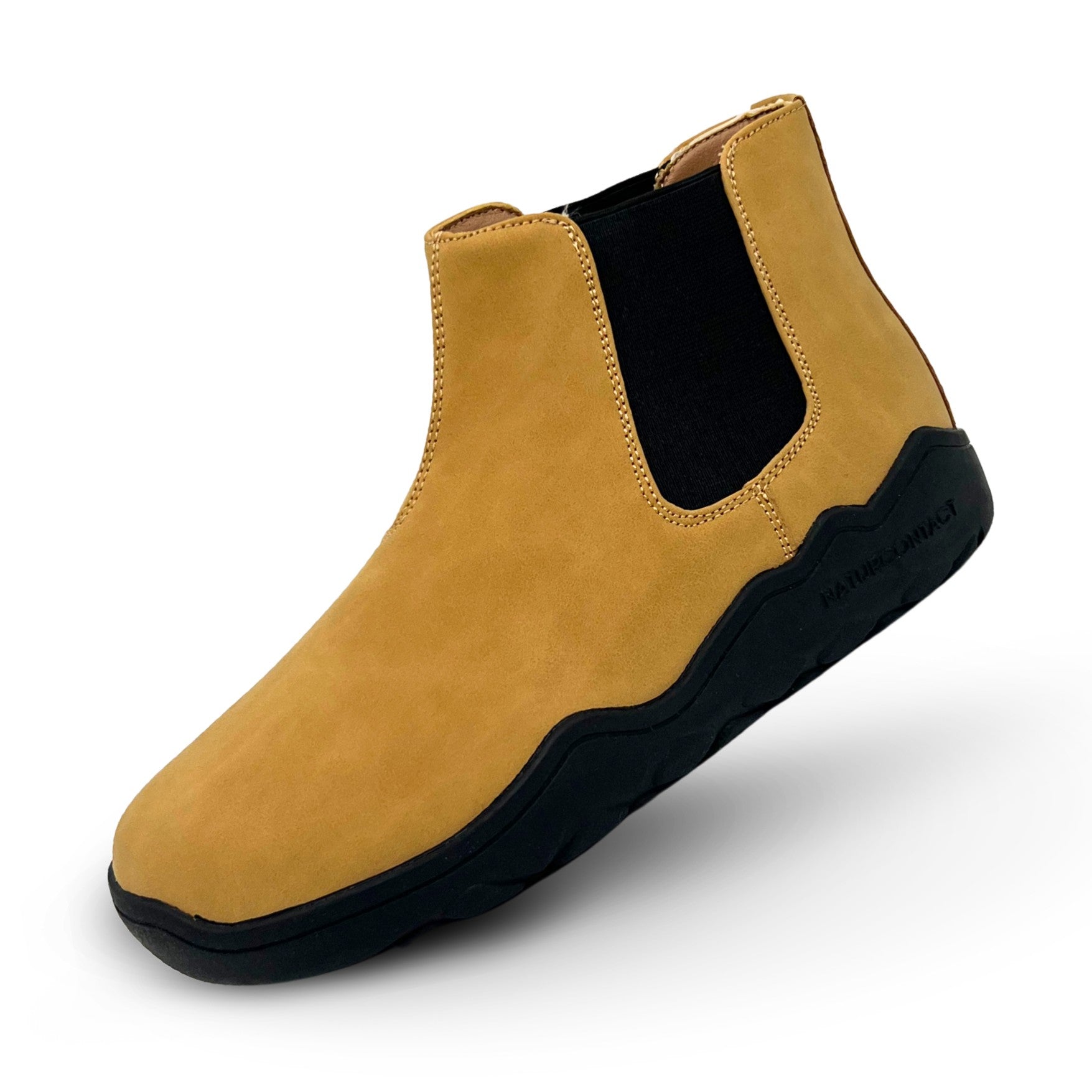Yellow Chelsea boot with black sole on a white background