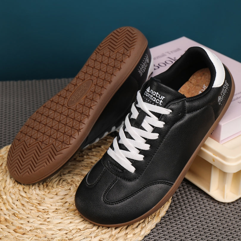 Barefoot Walker Leather black barefoot shoes displayed in a lifestyle setting